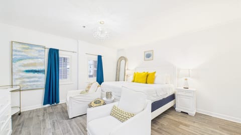 Studio layout with king bed and armchairs + HUGE TV (sleeps 2)