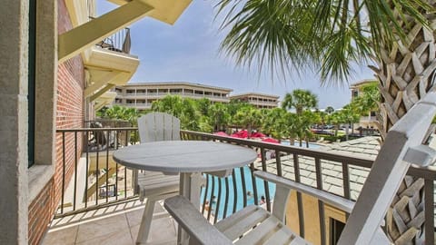 Balcony with table and seats overlooking resort amenities