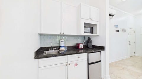 Kitchenette equipped with microwave mini fridge and coffee maker