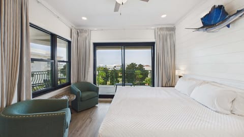 2 comfortable arm chairs at the foot of the bed and small table - perfect for morning coffee