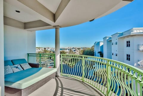 Spacious balcony with oversized lounge chair and extra seating.