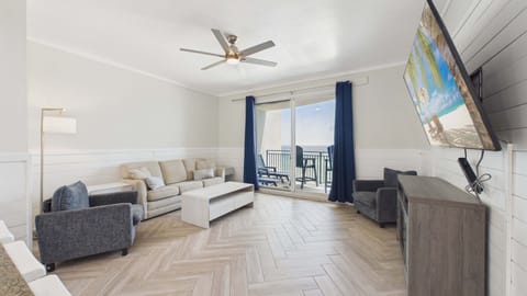 Open concept living area with huge TV and comfy furnishings + sleeper sofa (sleeps 2)