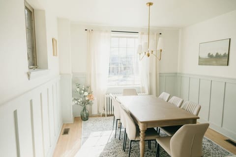 Elegant dining room with wooden table, and chandelier