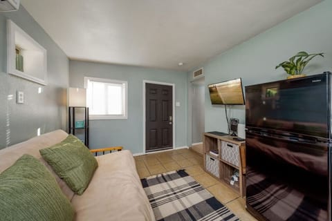 Living room area with smart TV and futon for additional sleeping space, if needed