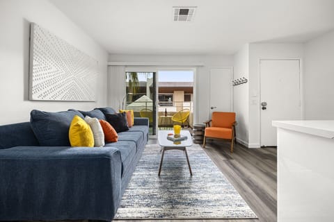 - Sunlit Palm Springs living space with patio access and colorful decor accents   - Lounge comfortably on the plush sofa or read by the sliding doors   - Cheerful interior offers modern comfort steps from downtown Palm Springs