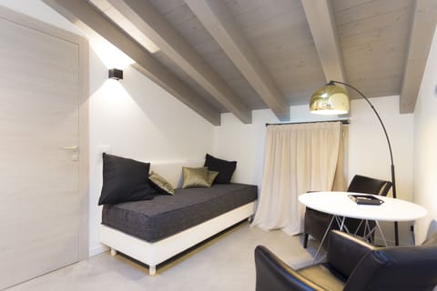 Luxury Studio Suite | Living area | 43-inch Smart TV with satellite channels, TV