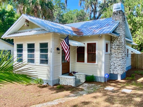 Welcoming exterior with stone chimney, cozy Nature Coast retreat awaits!