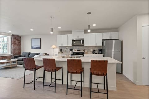Sleek, fully stocked kitchen with high-end appliances—perfect for home-cooked meals or morning coffee.