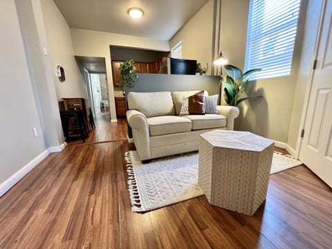 Bright living room with comfortable love seat and Roku TV (Hulu & Netflix)