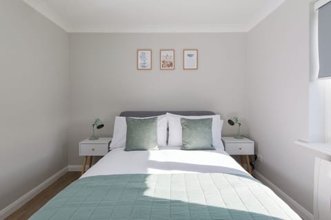 Bedroom with side tables and wall art 