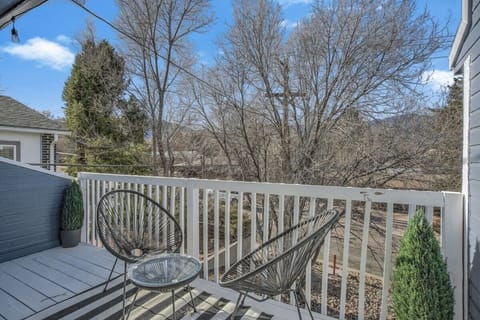 Start the day on the deck—two woven chairs and a bistro table for sipping something warm while you take in the treetop view beyond the white railing.