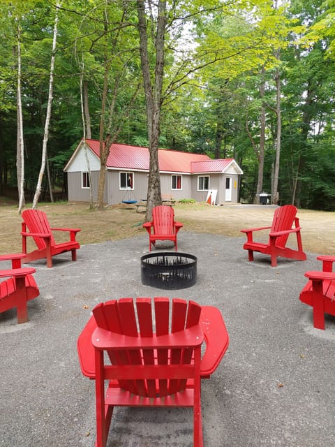 The outdoor firepit includes firewood and everything needed to start a fire.