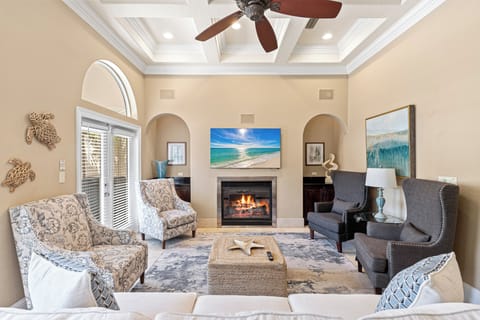 Unwind in your elegant living room with coastal touches, cozy fireplace, and comfortable seating perfect for relaxing evenings.