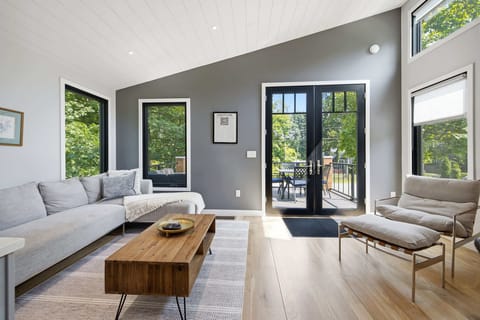 Vaulted living room with direct deck access expands your gathering space.