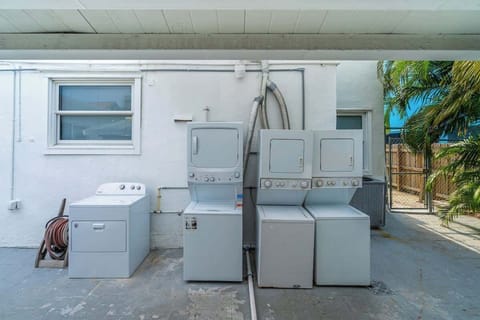 Enjoy the convenience of a shared laundry space with multiple machines and outdoor access—perfect for long-term guests or families on the go.