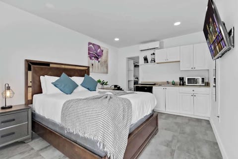 Bright studio with plush bedding, full kitchenette, and smart TV—perfect for short-term stays near the beach or city.