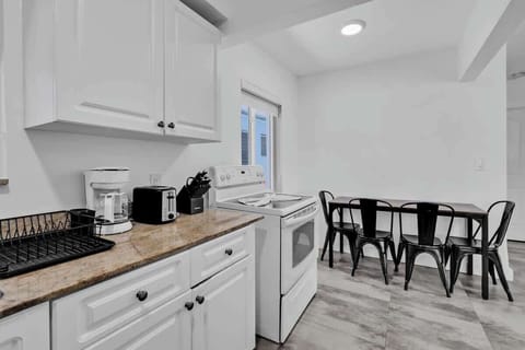 Functional kitchen and dining space with espresso machine and seating for six—great for long stays or family trips.