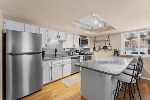Updated kitchen with stainless steel appliances and breakfast bar.