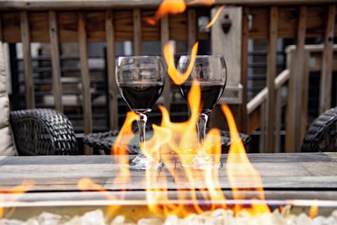 Cozy fire table patio with wine—perfect for relaxing evening nights