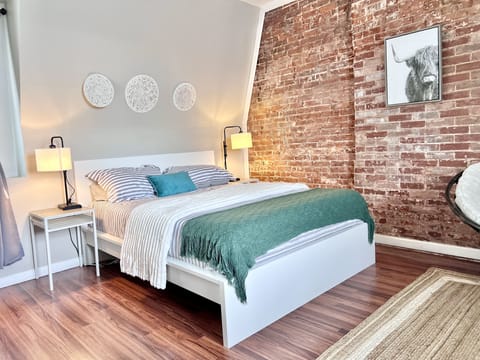 Comfy queen bed with nightstands and ambient lighting