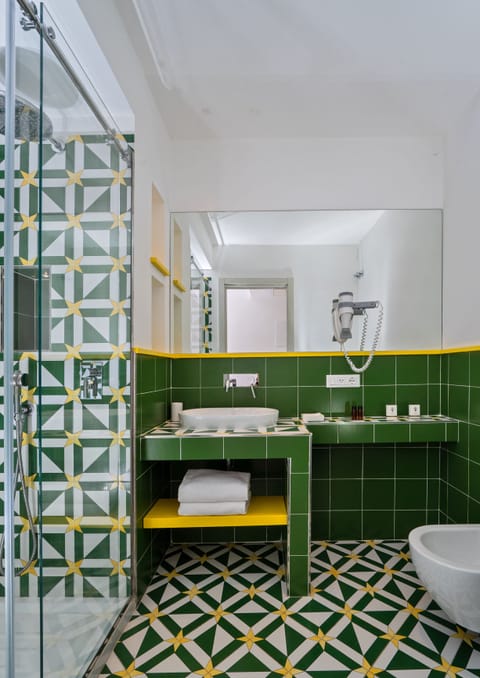 Combined shower/tub, designer toiletries, hair dryer, slippers