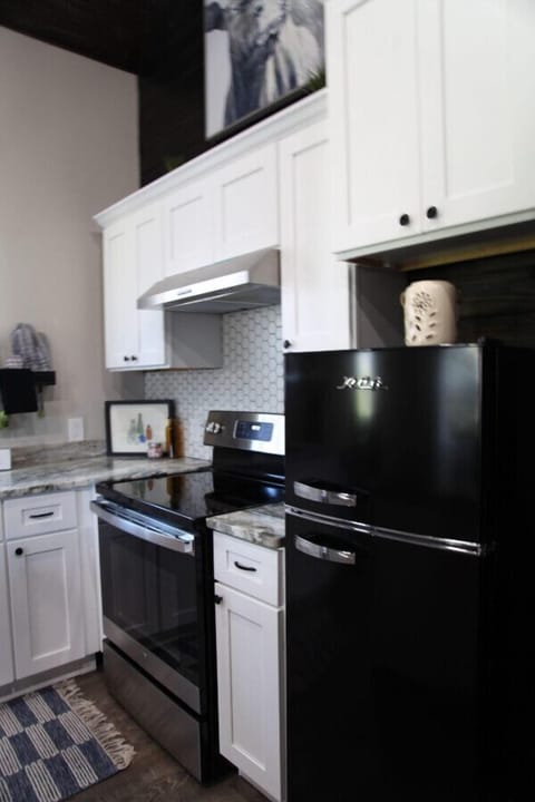 Our kitchen has more than just a full size oven and mid-size fridge, but pots, pans and all the utensils you`d need to prep up a good meal (or just reheat that pizza).