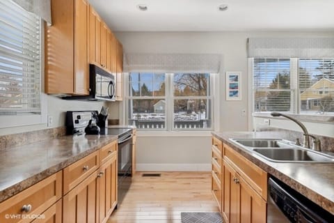 Cook with ease in this well-equipped kitchen with stove, dishwasher, and ample storage.