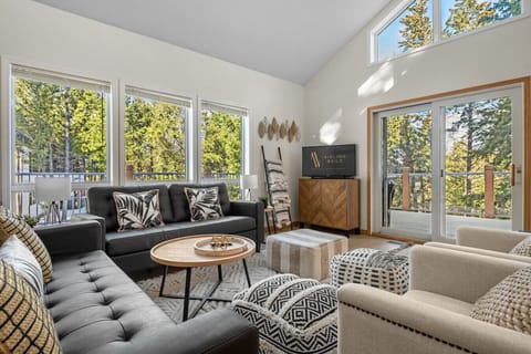 Living room with a Smart TV, cozy seating options and walkout access to the upper balcony.