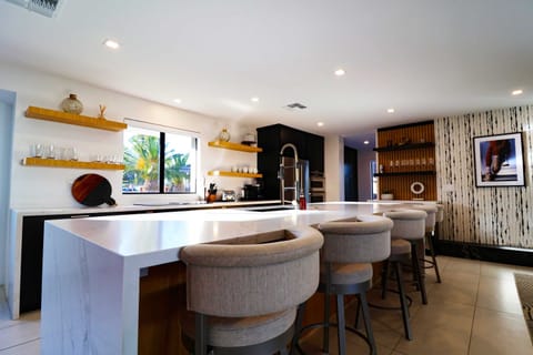 Beautiful kitchen island with luxe barstools and a fully stocked kitchen equipped with all the appliances you need for the perfect weekend!