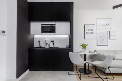 Kitchenette with plenty of kitchen utensils and dishes. 