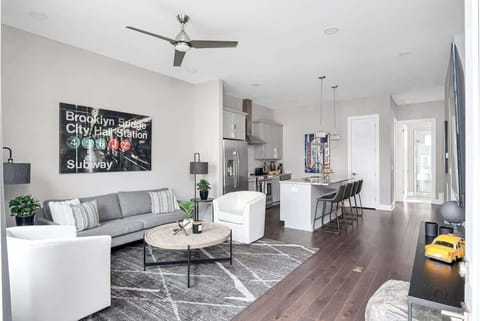 Light-filled lounge with modern seating and natural wooden floors.