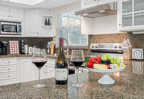 This kitchen is a masterpiece of design, with bright white painted cabinets that instantly elevate the space.