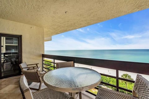 Oceanfront balcony with panoramic sea views and cozy seating