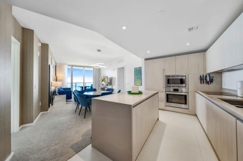 From the kitchen island you look out to the living room with panoramic windows.