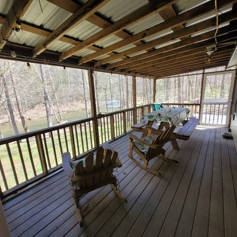 screened back porch for a picnic, card game or watching the creek in the rain