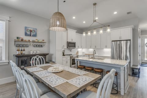 An indoor table and bar island seating as well as outdoor dining. 