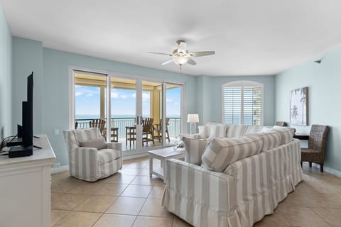 Beach Colony Tower 10C- Sink into coastal comfort in your spacious living room, where soft breezes and stunning ocean views welcome you home through your private balcony doors.