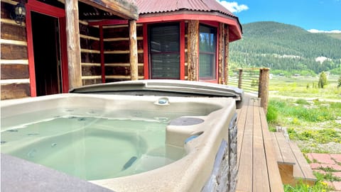 Relax in the hot tub while enjoying mountain views.