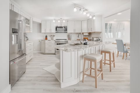 Additional Bar Stools adjacent to the remodeled kitchen