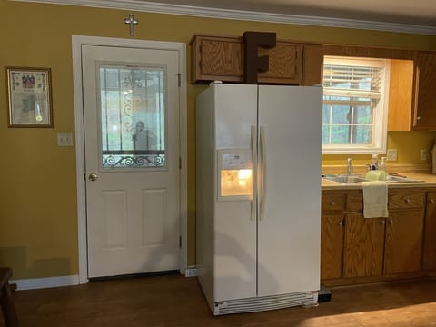 Kitchen with access door to screened porch and grill