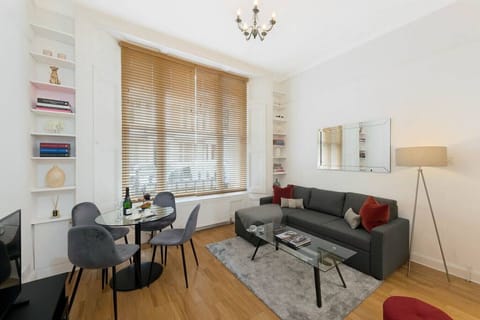 Living room - double sofa bed with bed linen always provided, Smart TV, dining table  & 4 chairs, large windows, books, mirror, lamp, coffee table