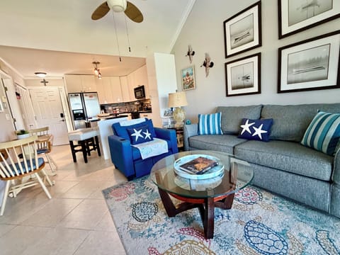 Living room area, integrated dining and fully equipped kitchen.