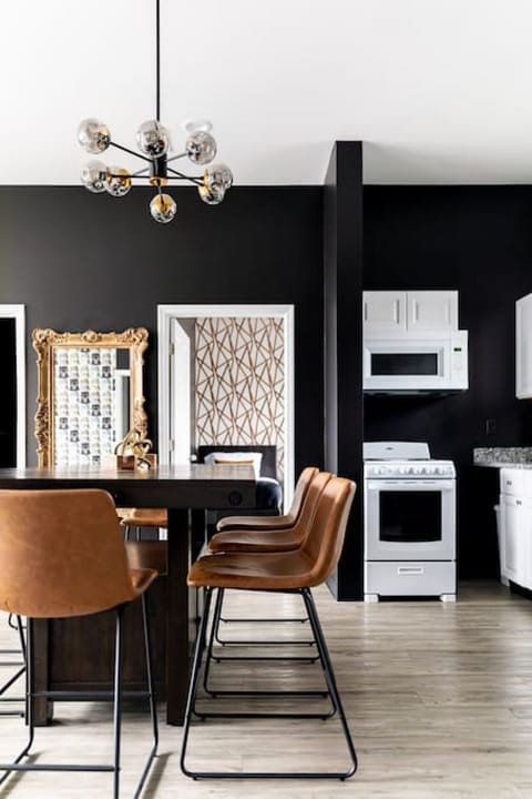 Fully equipped kitchen with drip coffee maker + coffee. Dining table with seating for 8. Full length mirror for getting ready. This room opens up into the living room. Unique wallpaper all throughout the condo.