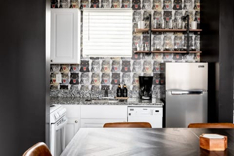 Fully equipped kitchen with drip coffee maker + coffee. Dining table with seating for 8. Full length mirror for getting ready. This room opens up into the living room. Unique wallpaper all throughout the condo.