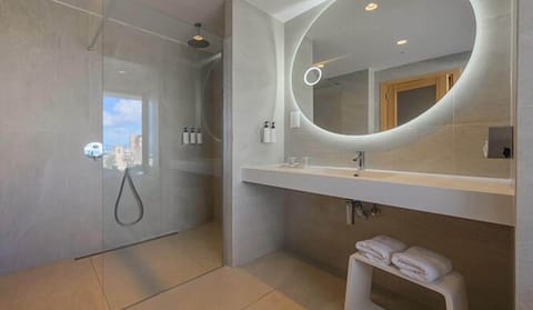 Deep soaking tub, rainfall showerhead, eco-friendly toiletries