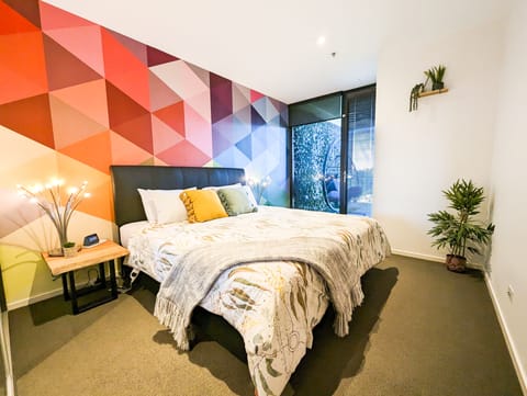 King size bed in the master bedroom, with direct access to the balcony