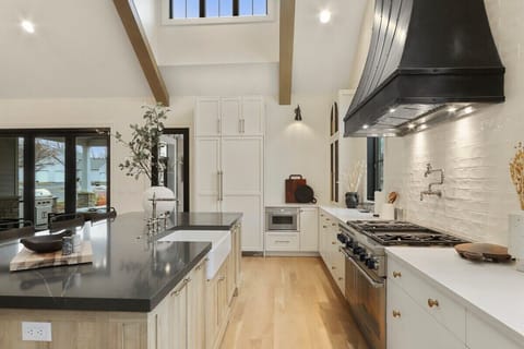 Fully equipped kitchen with skylight and breakfast bar seating for 4.