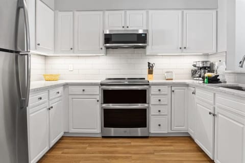 The well-laid-out kitchen is fully equipped with stainless steel appliances, all the basic cookware, and beautiful countertops and cabinets.
