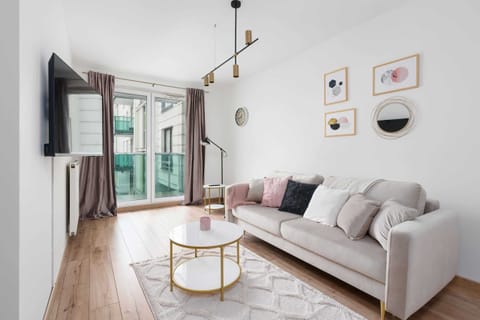 Relax in the stylish living room with a comfortable sofa and modern decor.