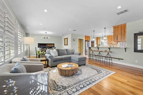 Open concept living space equipped with a flat screen TV and gas fireplace.